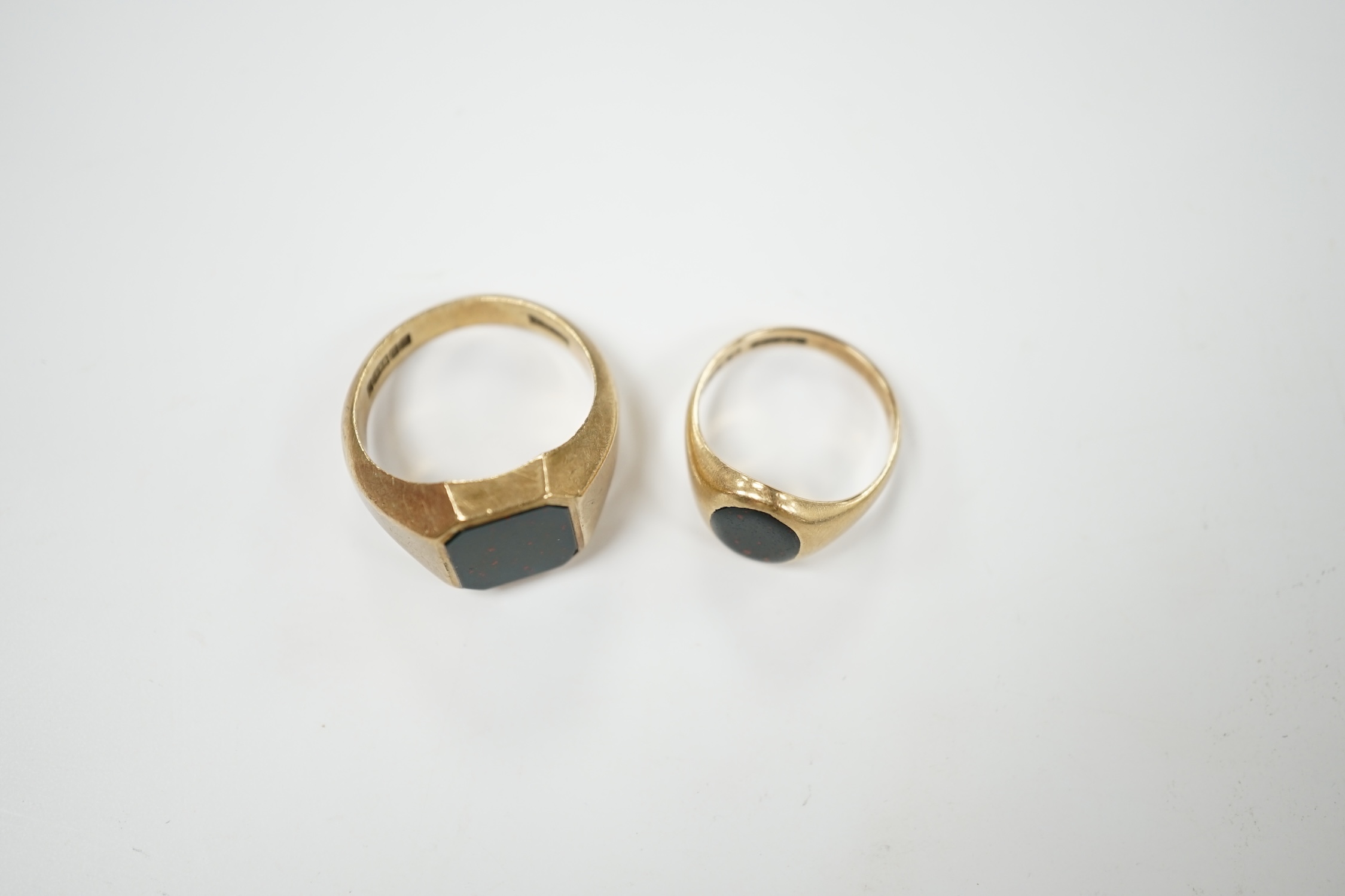 Two 9ct gold and bloodstone set signet rings, largest size Q, gross weight 11.5 grams. Condition - poor to fair